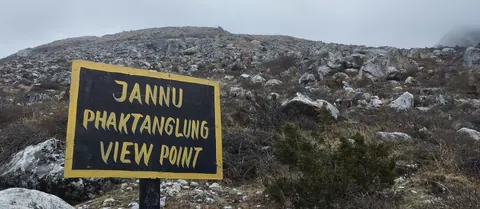 Painted sign for the Jannu Phaktanglung viewpoint on a boulder slope below Khambachen