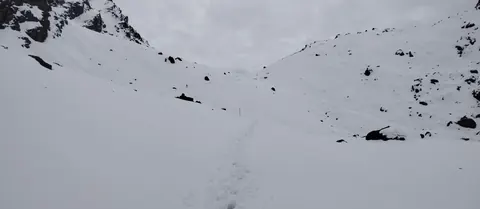 A line of footprints across a snowfield at about 4,570m on the Sele La pass complex