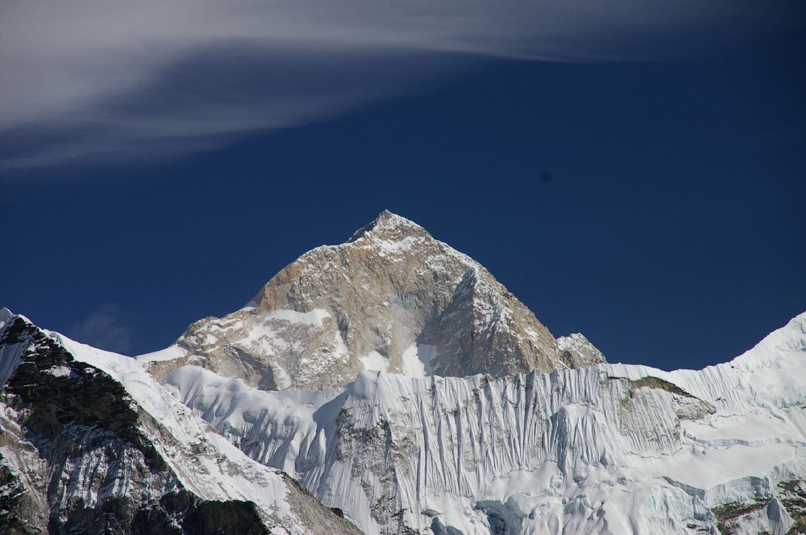 Makalu's pyramidal southwest face, wind-carved snow flutes down the flank.