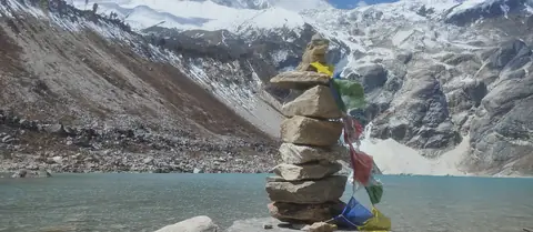 A prayer-flag cairn beside Birendra Tal, the glacial lake above Samagaon