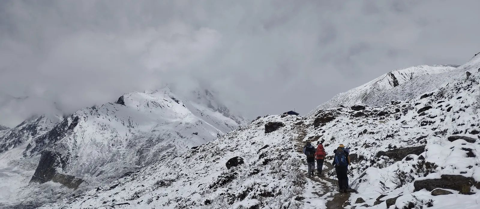 Trekkers on the snowy trail below Dharamsala