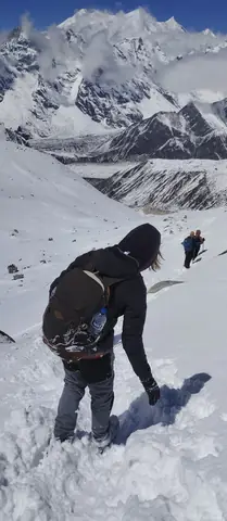 Trekker descending the snowfield on the Bimtang side of the Larkya La