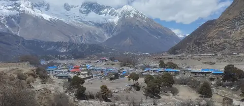 Samagaon village spread across the valley floor below the Manaslu massif