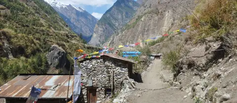 Stone houses and prayer flags along the trail in the upper Budhi Gandaki